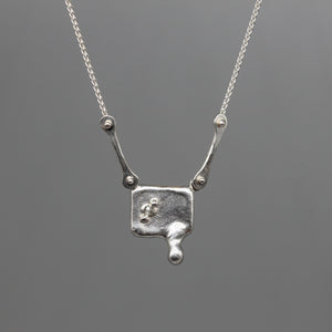 Moissanite and sterling silver square pendant