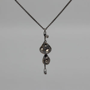 Double Oddity drop pendant necklace in blackened silver.