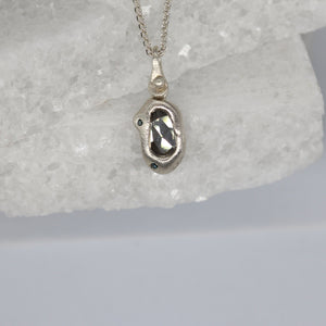 Diamond slice bean pendant necklace in sterling silver with blue diamonds