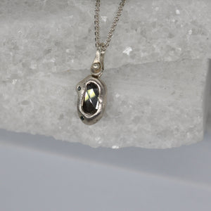 Diamond slice bean pendant necklace in sterling silver with blue diamonds