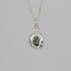 Diamond slice pendant necklace in sterling silver with blue diamonds by Tamara Gomez