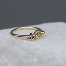 Load image into Gallery viewer, Side view of a handmade yellow gold twist ring with a subtle grey moissanite