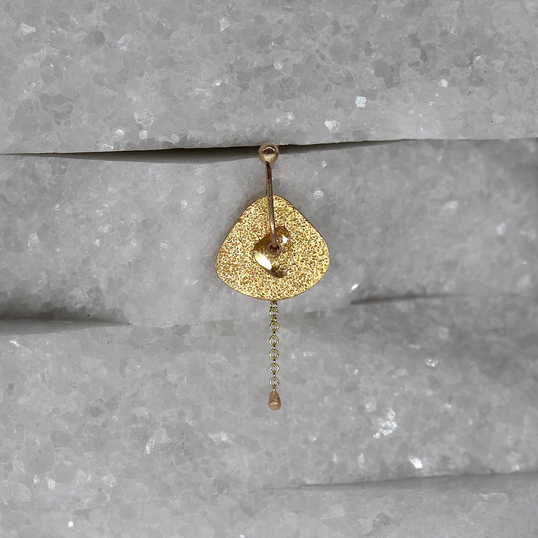 Single diamond slice stud earring in yellow gold with chain by Tamara Gomez