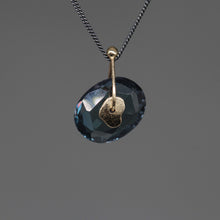 Load image into Gallery viewer, Inkwash blue watercolour sapphire sequin pendant necklace in 9ct yellow gold on a darkened sterling silver chain, handcrafted in London by Tamara Gomez.

