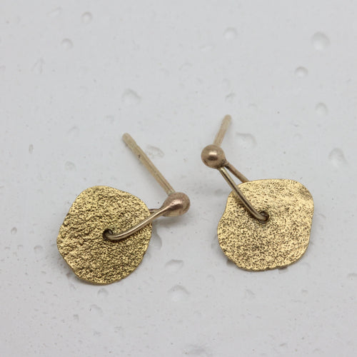 Gold sequin stud earrings by Tamara Gomez