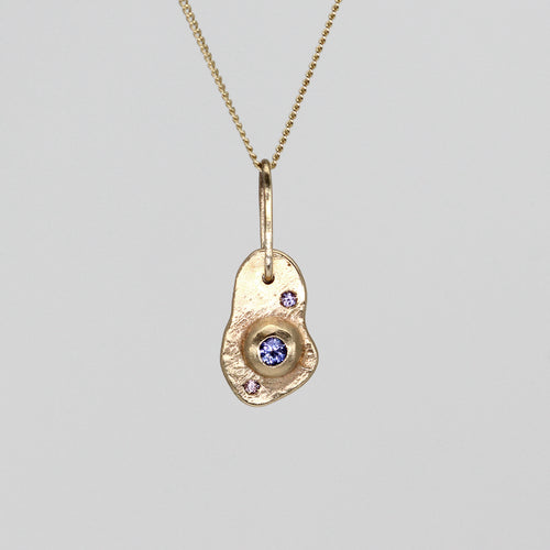 Oddity sculptural pendant necklace in yellow gold with sapphires