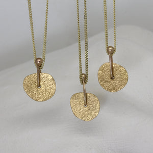 Gold sequin pendant necklace by Tamara Gomez